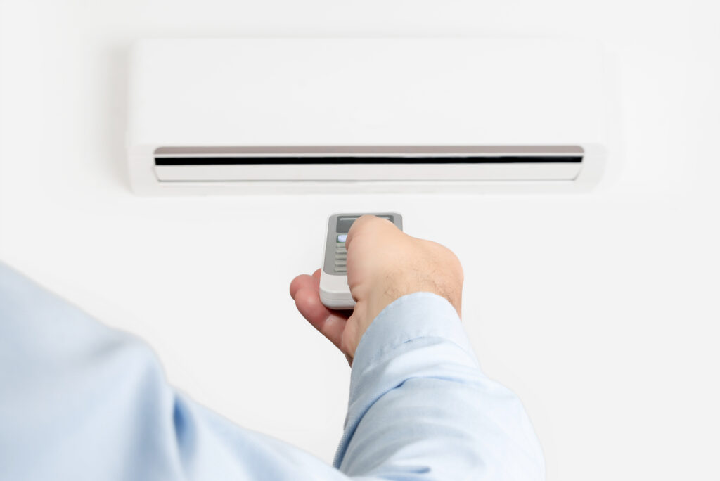 Vermont HVAC technician adjusting air conditioner