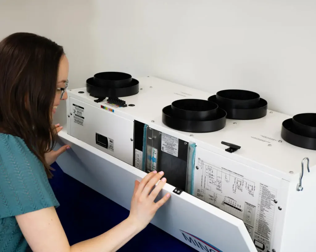 Technician checking heat pump system indoors