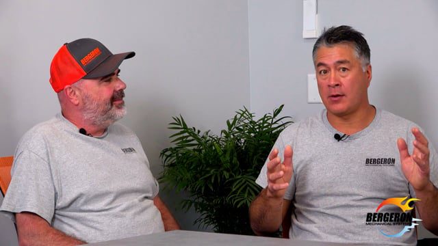 Men discussing heat pump installation New Hampshire