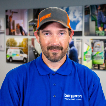 Vermont HVAC technician in uniform smiling
