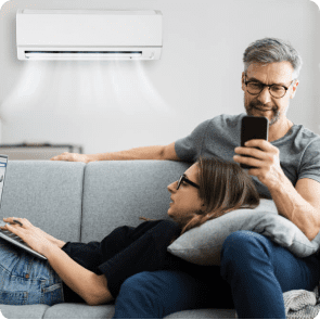 Couple relaxing under Vermont HVAC air conditioner