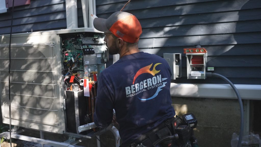 HVAC technician repairing outdoor air conditioner