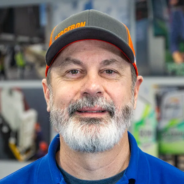Smiling man with gray beard and cap